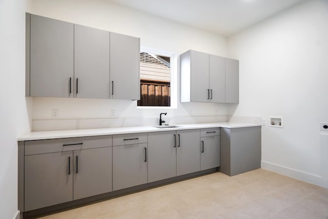 kitchen featuring sink and gray cabinetry