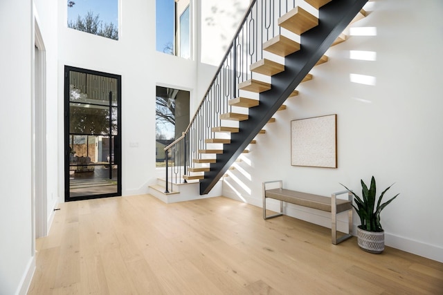 foyer with light wood-type flooring and a high ceiling