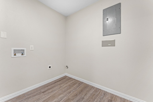 washroom with hookup for an electric dryer, electric panel, hookup for a washing machine, and hardwood / wood-style floors