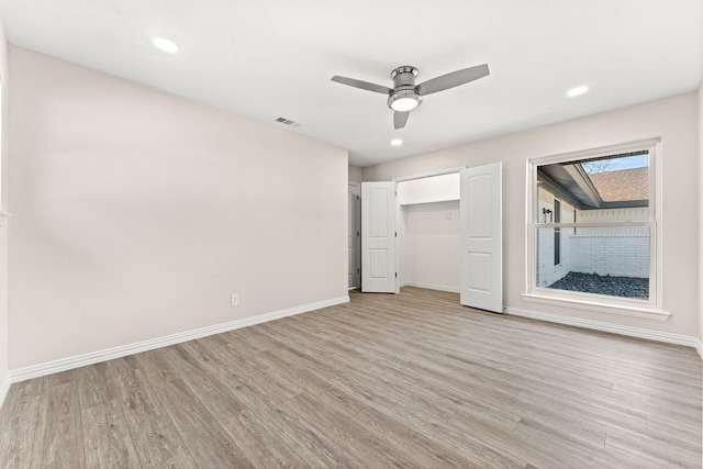 unfurnished bedroom with ceiling fan and light hardwood / wood-style floors