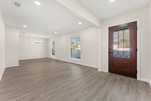 foyer featuring a chandelier and light hardwood / wood-style flooring