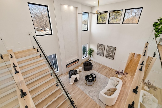 stairway featuring wood-type flooring and plenty of natural light