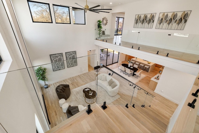 living room with hardwood / wood-style floors and ceiling fan