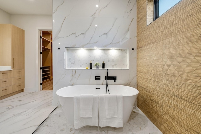 bathroom with a bath and tile walls