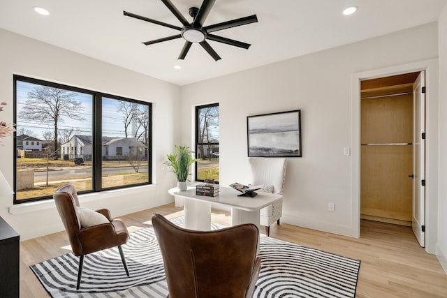 office space with ceiling fan, a wealth of natural light, and light wood-type flooring