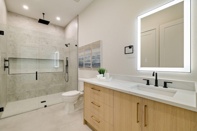 bathroom featuring vanity, toilet, an enclosed shower, and tile patterned flooring