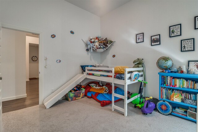 bedroom featuring vaulted ceiling and light colored carpet