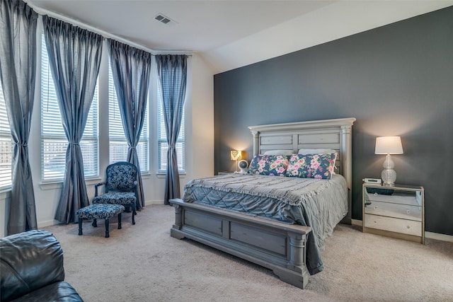 carpeted bedroom with lofted ceiling