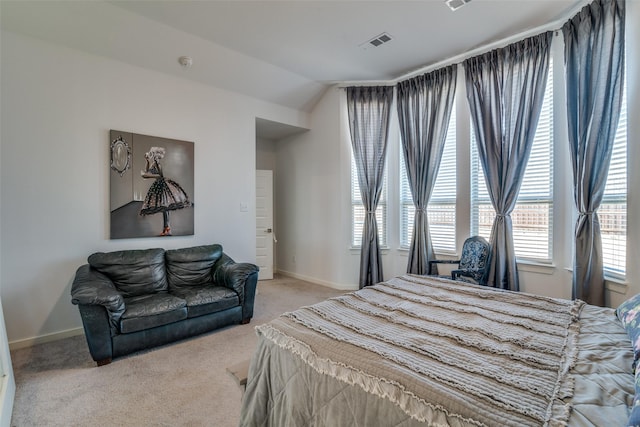 carpeted bedroom with lofted ceiling