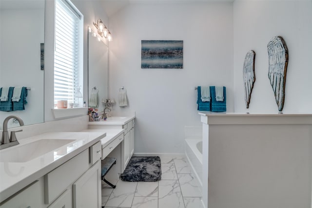 bathroom with vanity and a bath