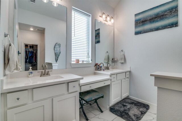 bathroom featuring vanity, a healthy amount of sunlight, and a tub to relax in