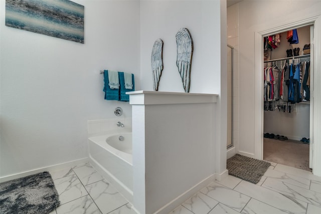 bathroom featuring separate shower and tub