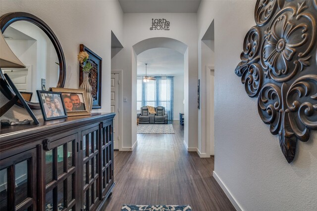 foyer entrance with a notable chandelier, a towering ceiling, and dark hardwood / wood-style floors