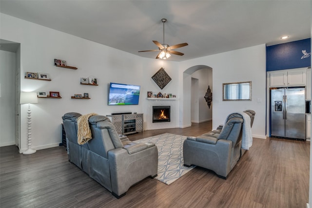 living room with dark hardwood / wood-style flooring and ceiling fan