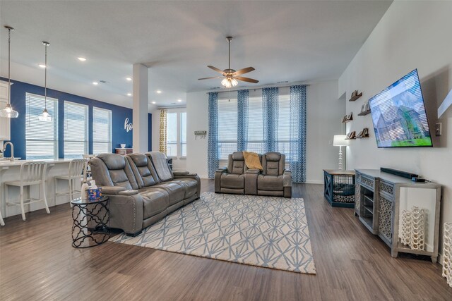 living room featuring ceiling fan and dark hardwood / wood-style flooring