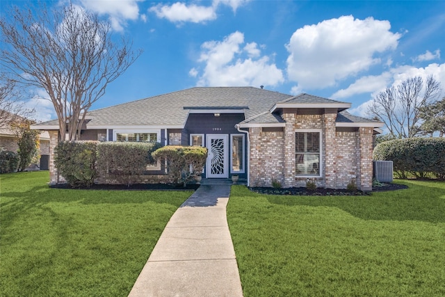 view of front of home featuring a front yard and cooling unit