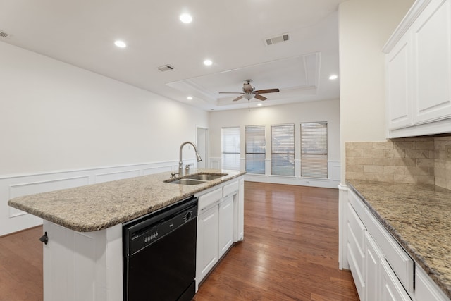 kitchen featuring dishwasher, a raised ceiling, sink, white cabinets, and a kitchen island with sink