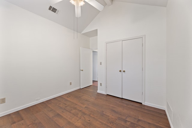 unfurnished bedroom with a closet, high vaulted ceiling, beam ceiling, dark hardwood / wood-style flooring, and ceiling fan