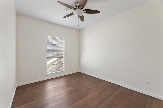 empty room featuring ceiling fan and dark hardwood / wood-style flooring