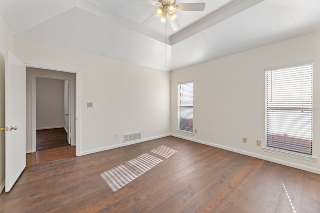 spare room with ceiling fan, a raised ceiling, and dark hardwood / wood-style floors