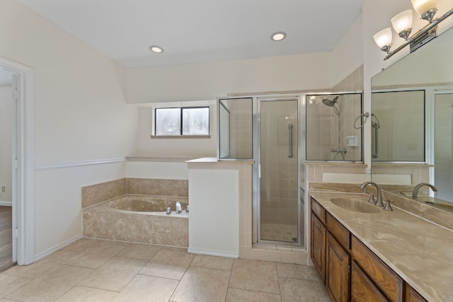 bathroom featuring vanity, independent shower and bath, and tile patterned floors