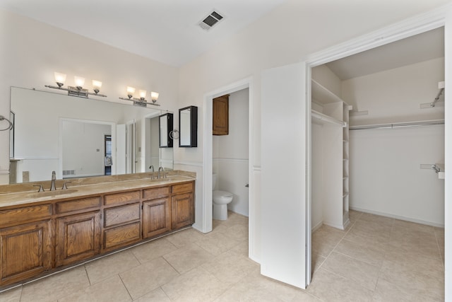 bathroom featuring toilet and vanity