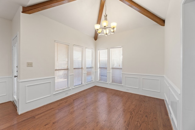 unfurnished dining area with wood-type flooring, lofted ceiling with beams, and a notable chandelier