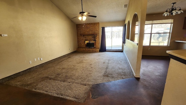 unfurnished living room featuring dark carpet, ceiling fan with notable chandelier, vaulted ceiling, and a textured ceiling