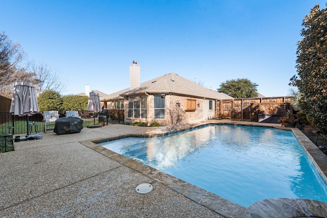 view of swimming pool featuring a patio area