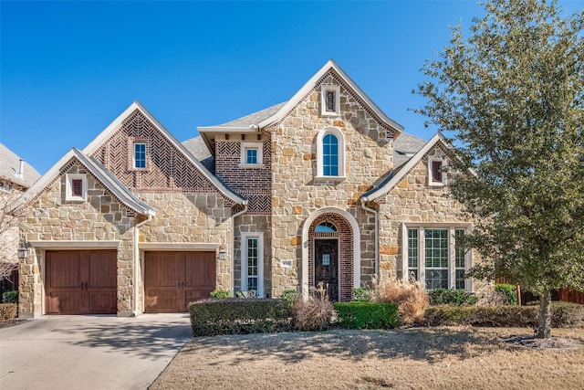 tudor house featuring a garage