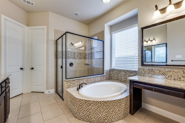 bathroom with vanity, tile patterned floors, and separate shower and tub