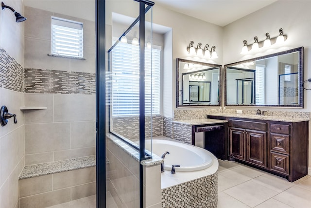 bathroom with tile patterned floors, vanity, and separate shower and tub