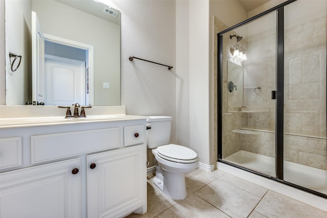 bathroom featuring toilet, tile patterned flooring, walk in shower, and vanity