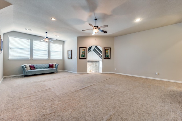 unfurnished living room with lofted ceiling, light colored carpet, and ceiling fan