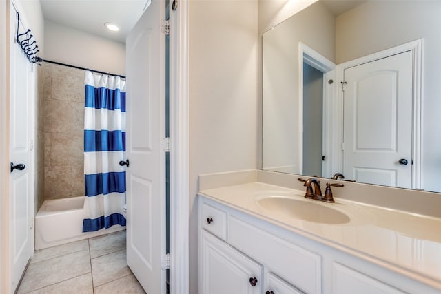 bathroom with shower / tub combo, tile patterned floors, and vanity