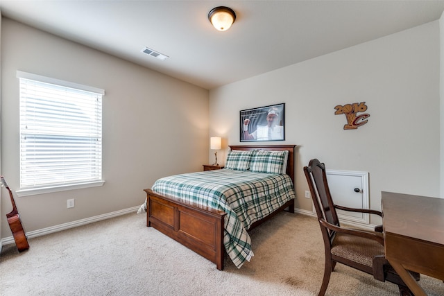 carpeted bedroom featuring multiple windows