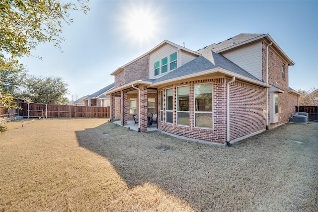 back of house with a patio, central AC, and a yard