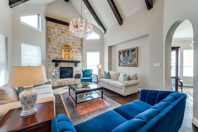 living room with a fireplace, dark wood-type flooring, high vaulted ceiling, and a wealth of natural light