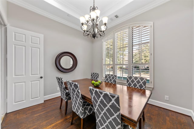 dining room with crown molding, dark wood-type flooring, and an inviting chandelier