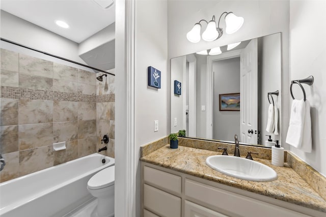 full bathroom with vanity, toilet, and tiled shower / bath