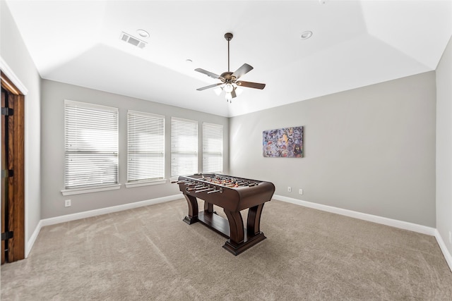 game room with light carpet, baseboards, visible vents, and a raised ceiling