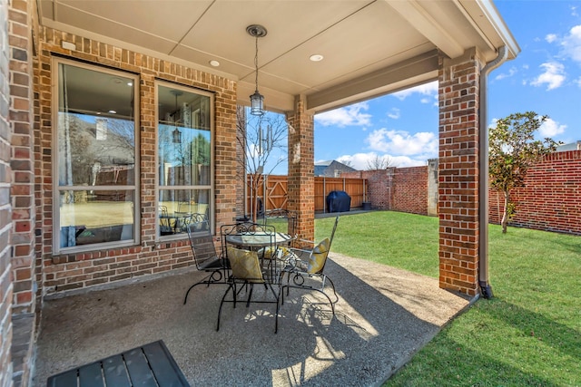 view of patio / terrace with a fenced backyard, grilling area, and outdoor dining space