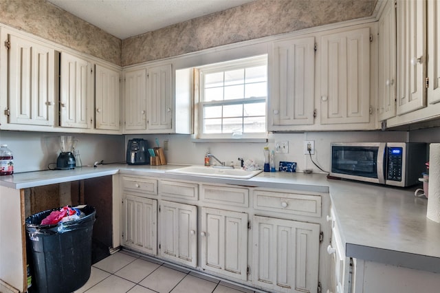 kitchen featuring sink and light tile patterned floors