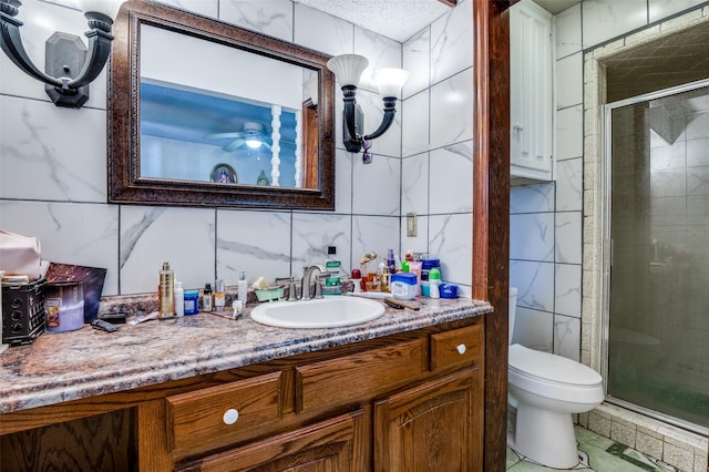 bathroom featuring vanity, toilet, tile walls, and an enclosed shower