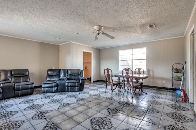 living room with ceiling fan, a textured ceiling, and ornamental molding