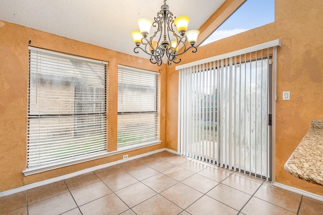 unfurnished dining area with tile patterned flooring, vaulted ceiling, and a chandelier