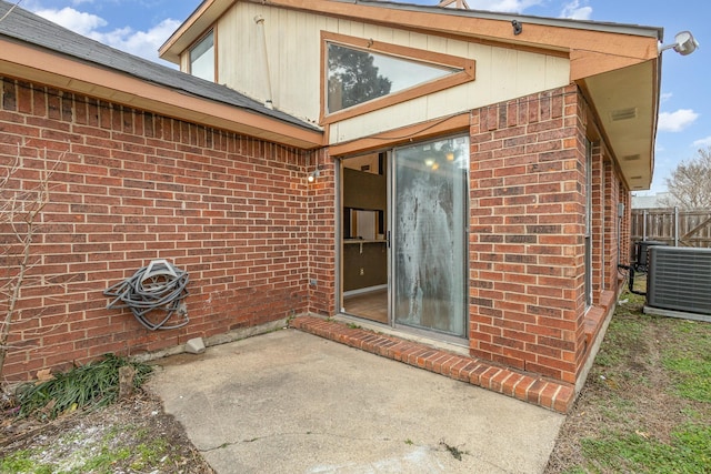 entrance to property with a patio area and central air condition unit