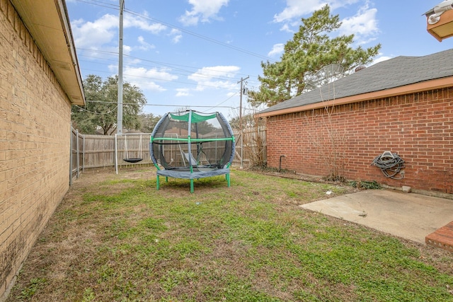 view of yard featuring a trampoline and a patio area