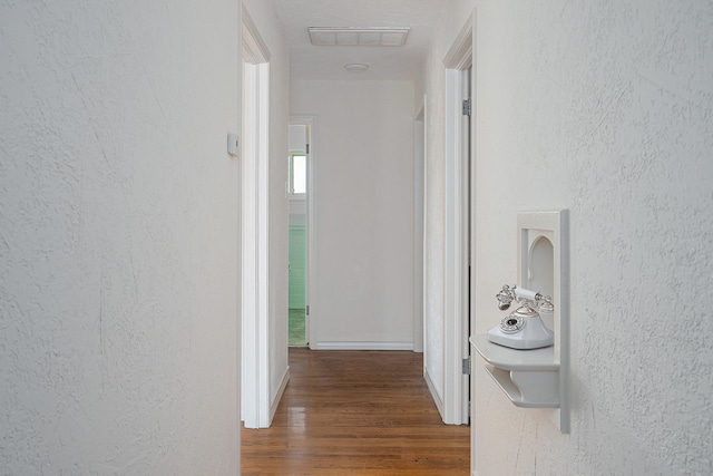 hallway with dark hardwood / wood-style floors