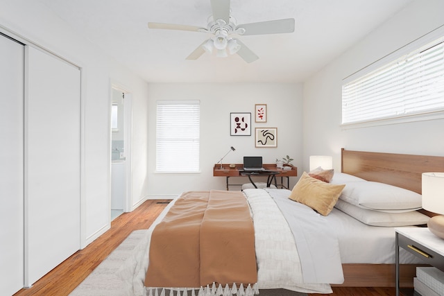 bedroom featuring ceiling fan, a closet, and light wood-type flooring